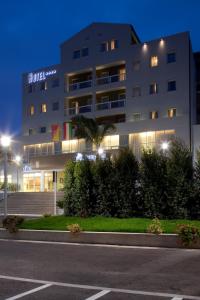 un gran edificio con luces frente a una calle en Hotel Torre Del Sud, en Módica