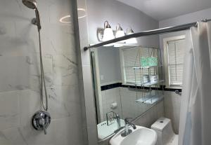 a white bathroom with a sink and a shower at The Peahen House in San Antonio +23 photos
