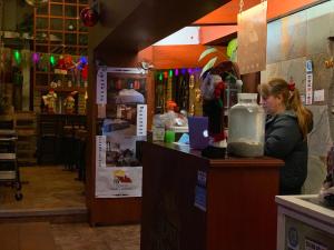 a woman sitting at a counter in a restaurant at Quinta Maria Bonita Hotel Boutique in Xalapa