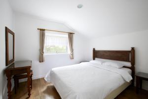 Postel nebo postele na pokoji v ubytování Club ES Jecheon Resort