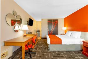 a hotel room with a bed and a desk at Howard Johnson by Wyndham Virginia Beach in Virginia Beach +31 photos