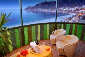 a table and chairs with a view of the beach at KAKTUS Hotel Kaktus Albir in Albir