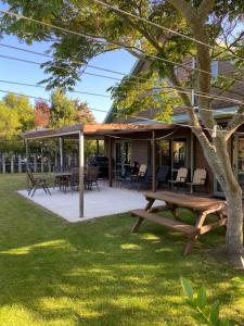 a pavilion with a picnic table and chairs at Abel Tasman Marahau in Marahau