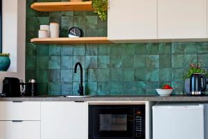 a kitchen with a sink and a microwave at 52Views Castlemaine in Castlemaine