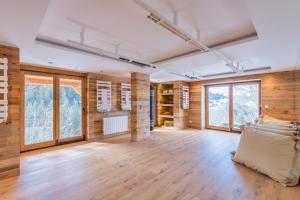 a large room with wooden walls and large windows at Chalet Les Meuniers in Megève