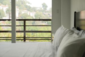 a bedroom with a bed and a view of a balcony at Hollywood Hills Hotel in Los Angeles