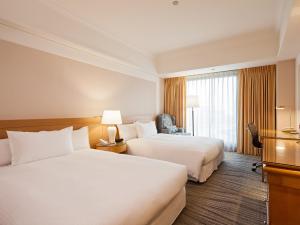Postelja oz. postelje v sobi nastanitve RSL Hotel Taipei Zhonghe