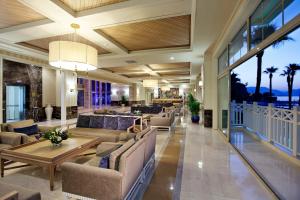 a lobby of a resort with couches and a table at Quadas Hotel - Adult Only in Marmaris