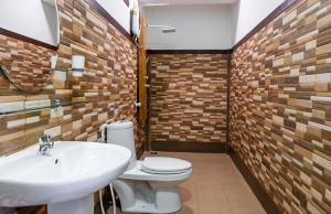 a bathroom with a white toilet and a sink at Salt Villa Ukulhas in Ukulhas