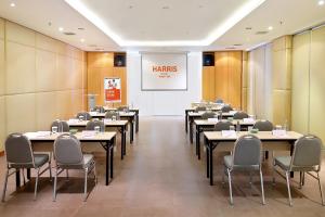 a conference room with tables and chairs and a white wall at HARRIS Hotel Kuta Tuban Bali in Kuta