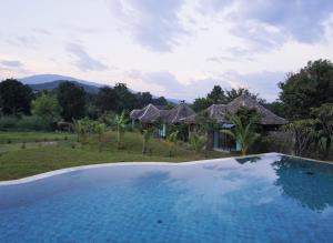 a swimming pool in front of a villa at Hideaway in Chiang Mai