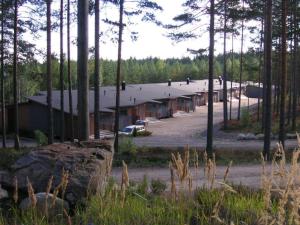 a large building in the middle of a forest at Kuoreksenniemi Villas & Lakehouse in Puumala