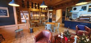 a restaurant with tables and chairs and a counter at The Aarburg Hotel & Café in Interlaken