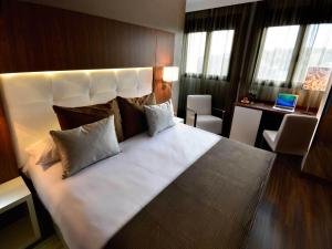 Postel nebo postele na pokoji v ubytování Gran Hotel Botánicos