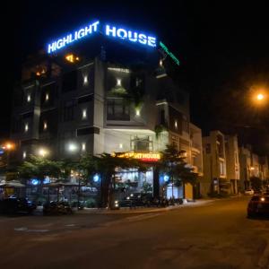 a building with a light house at night at HighLight House Hotel & Coffee in Pleiku