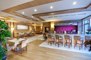 a restaurant with a bar with tables and chairs at Quadas Hotel - Adult Only in Marmaris