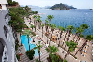 an aerial view of a beach with palm trees and the water at Quadas Hotel - Adult Only in Marmaris