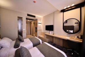 a hotel room with two beds and a television at Best Western Plus Center Hotel in Ankara
