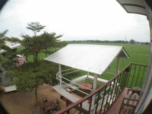 a view of a porch with a white roof at Slowlife House Ayothaya in Phra Nakhon Si Ayutthaya