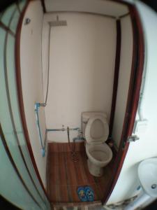 a small bathroom with a toilet in a boat at Slowlife House Ayothaya in Phra Nakhon Si Ayutthaya