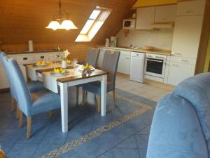 a kitchen and dining room with a table and chairs at Ferienwohnung-Dorette-in-Stakendorf-mit-Blick-ueber-den-Dorfteich in Stakendorf