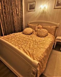 a bed with two pillows on it in a bedroom at Hotel Lux Angliter in Vologda
