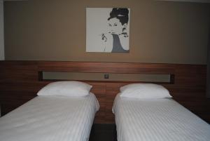 Postel nebo postele na pokoji v ubytování Hotel Du Soleil