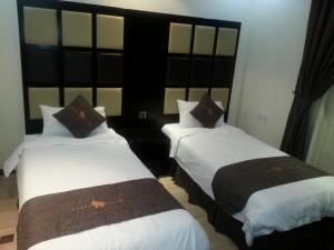 Una cama o camas en una habitación de Dorar Darea Serviced Apartments - Al Malqa