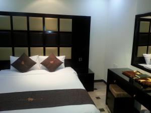 Una cama o camas en una habitación de Dorar Darea Serviced Apartments - Al Malqa