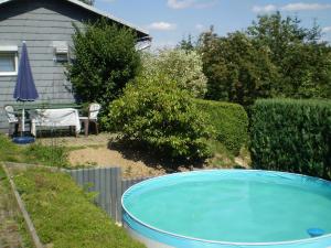 a swimming pool in a yard next to a house at Holiday home in Thuringia in Neuhaus am Rennweg