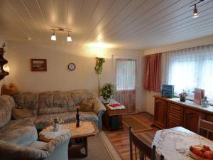 un soggiorno con divano e tavolo di Holiday home in Thuringia a Neuhaus am Rennweg