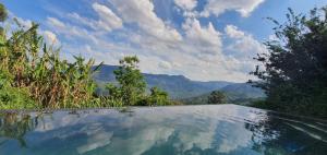 a swimming pool with a view of the mountains at Lind End Guest Farm in Haenertsburg