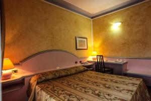 Postel nebo postele na pokoji v ubytování Hotel Grazia Deledda