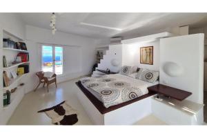 a white bedroom with a bed and a view of the ocean at Villa Pastorale-View-Boule Bahn in Agia Irini Paros