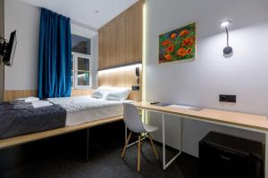 מיטה או מיטות בחדר ב-IZZZI by Gostiny dvor