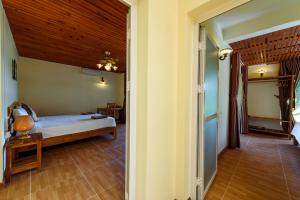 Postel nebo postele na pokoji v ubytování Mango Beach Resort