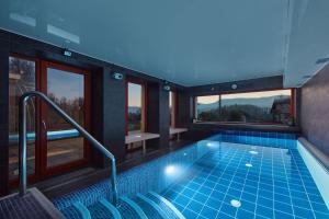 a pool in a house with a view at Hotel Slunný Dvůr in Jeseník