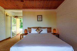 Postel nebo postele na pokoji v ubytování Mango Beach Resort