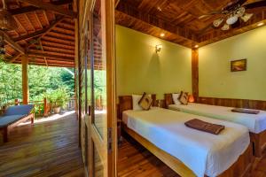 Postel nebo postele na pokoji v ubytování Mango Beach Resort