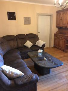 a living room with a couch and a coffee table at Ferienwohnung Am Schaumberg in Tholey