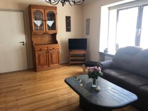 a living room with a couch and a coffee table at Ferienwohnung Am Schaumberg in Tholey