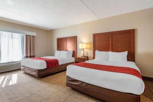 a hotel room with two beds and a window at Comfort Inn & Suites Morehead in Morehead