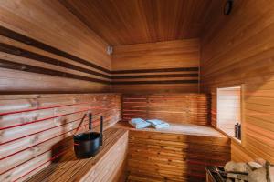 a sauna with a bucket and two towels in it at Nádas Center Home Badacsony in Badacsonytomaj