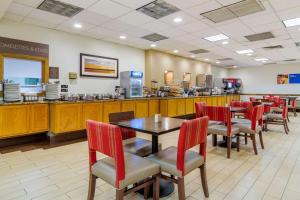 a restaurant with a table and chairs and a counter at Comfort Inn Denver Central in Denver