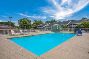 a swimming pool with chairs at Quality Inn Greenville near University in Greenville