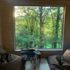 a room with a large window and a table in front at Farm Stay Happy Dogs Ranch in Veberöd