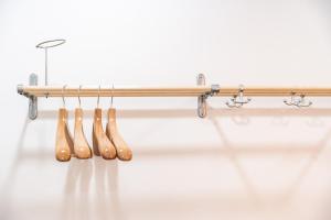 a group of wooden baseballoons hanging on a rack at Apartment City in Oulu