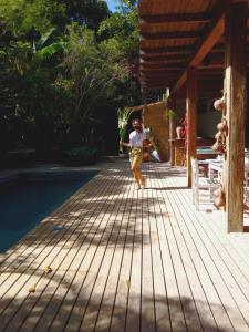 een persoon die naast een zwembad in de lucht springt bij Casa da Glória Trancoso - Pousada Boutique in Trancoso