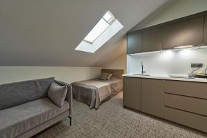 a room with a couch and a bed and a kitchen at Selini Hotel İstanbul Airport in Istanbul