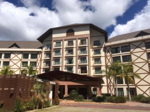 a large building with trees in front of it at Vista Azul Flat Service in Domingos Martins